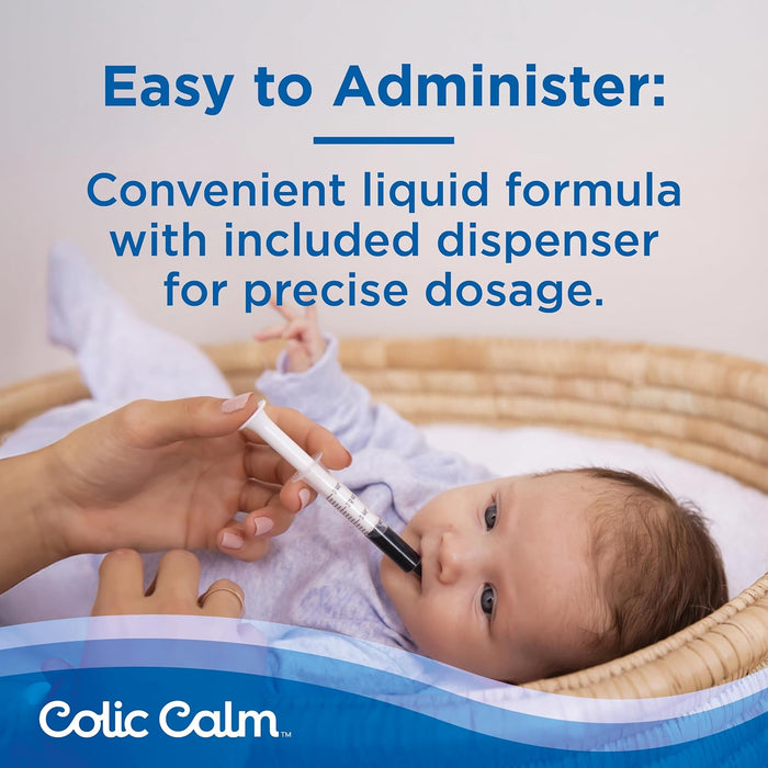 Baby is being fed with a Colic Calm liquid formula and dispenser.