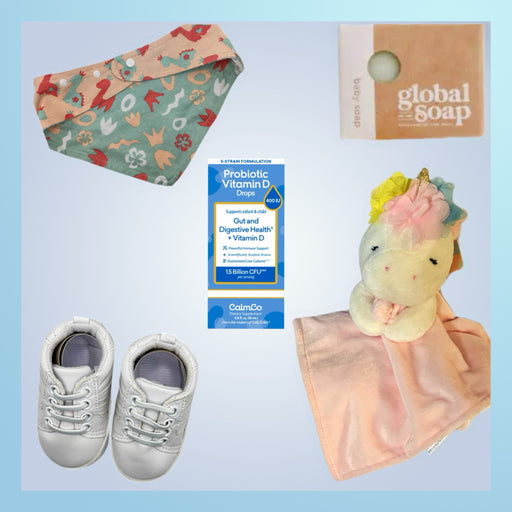 Complete baby wellness gift set with CalmCo Probiotic Vitamin D for infants, plush unicorn security blanket, stylish reversible bandana bib, organic Global Soap for sensitive skin, and soft-soled white baby sneakers.